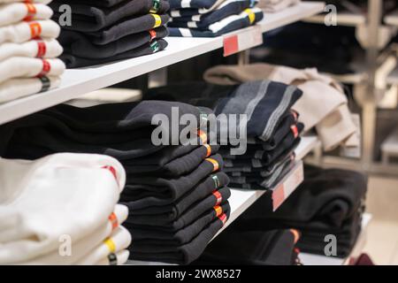 Jackets on hangers in a shop window close up Stock Photo