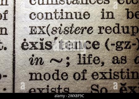 Word existence on dictionary page, macro close-up Stock Photo