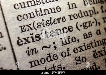 Word existence on dictionary page, macro close-up Stock Photo
