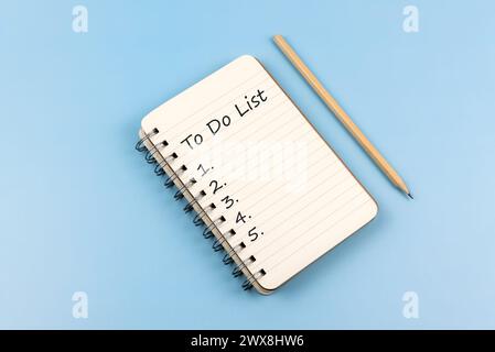To do list text on notepad on blue background Stock Photo