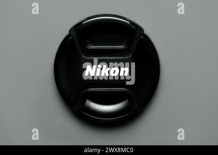 Close up of of Nikon camera lens cap on gray background. Illustrative editorial Stock Photo