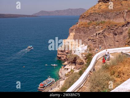 View of the Santorini Old Port called Skala and the winding path down the Caldera Cliff where you can hire a donkey to ride on. Stock Photo