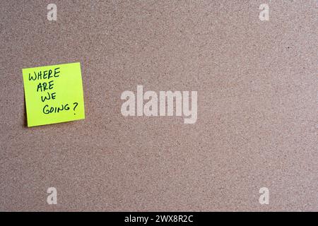 The words Where Are We Going on a yellow sticky note posted on a corkboard Stock Photo