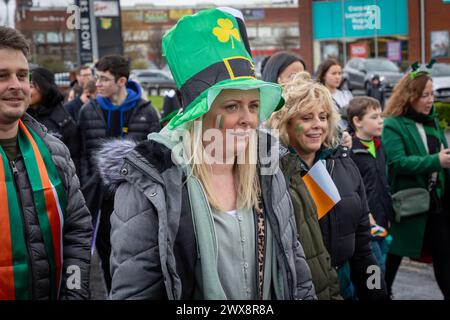 Young female wearing a flimsy St Patrick's Day hat during Warrington's 2024 procession Stock Photo