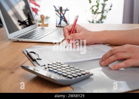 Accountant working on desk using calculator for calculate finance. Businessman calculating business balance. Stock Photo