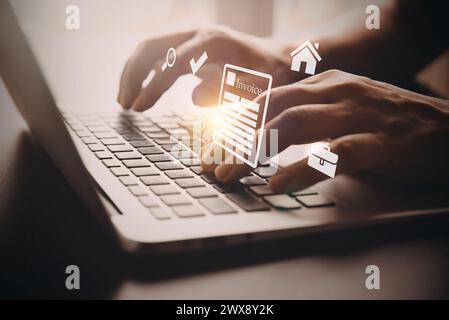 Man typing on a laptop. Invoice concept, flying icons Stock Photo