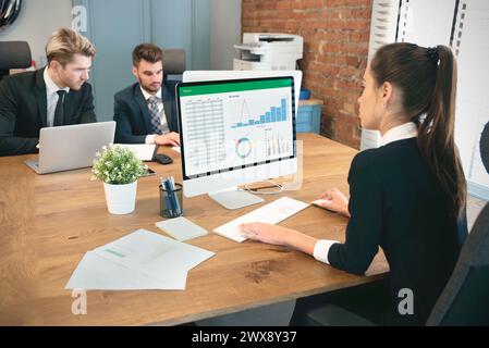 Employees work in the office, co-workers work on a common project Stock Photo