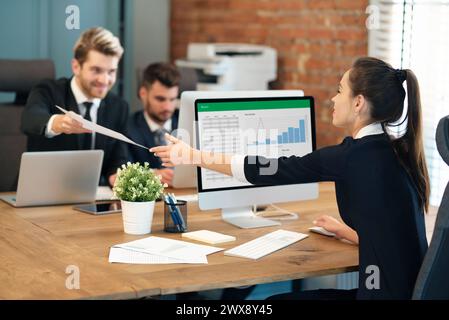 Employees work in the office, co-workers work on a common project Stock Photo