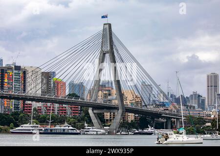 Anzac Bridge in Sydney connecting Pyrmont ( pictured) to Glebe, boats in the bay and Sydney city centre with high rise apartment buildings, Australia Stock Photo