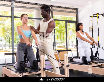 Positive African American male coach helping woman Stock Photo