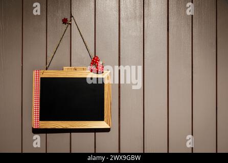 blackboard with frame hanging on a wooden wall, red heart Stock Photo