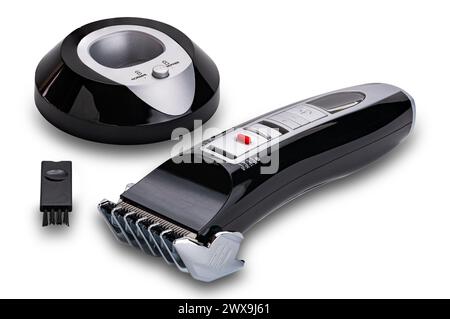 Set of pet hair clipper with charging base and cleaning brush isolated on white background with clipping path. Stock Photo