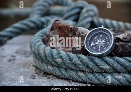 Navigation compass in outdoor with ropes on port Stock Photo