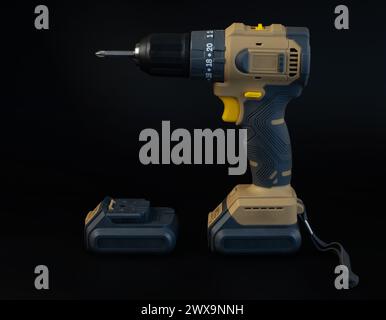 Cordless brushless screwdriver on black background. Stock Photo
