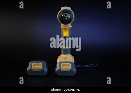 Cordless brushless screwdriver on black background. Stock Photo