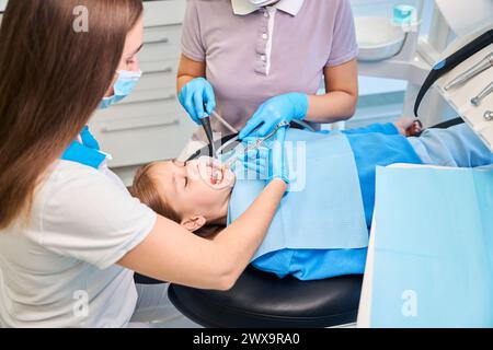 Doctor gives an injection with an anesthetic to girls gums Stock Photo