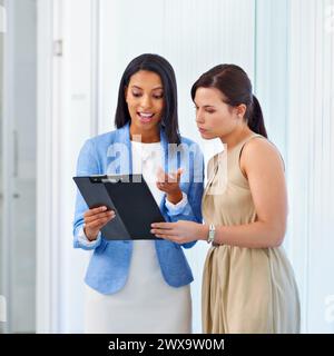Business woman, clipboard and discussion with documents for planning, schedule or results at the office. Female person or team looking at checklist Stock Photo