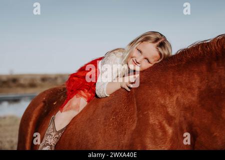 Blonde Charm: 4-Year-Old Girl and Her Horse Forge Unbreakable Bond! Stock Photo