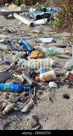 A chaotic array of glass bottles scattered on the ground, creating a stunning visual landscape of colors and shapes. Chantaburi Thailand  Stock Photo