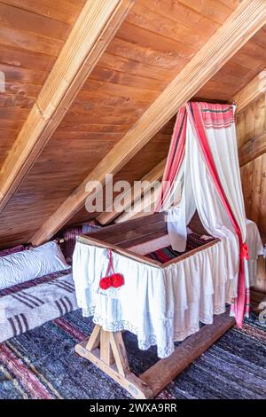 Old wooden handmade cradle-bed for a newborn. Stock Photo