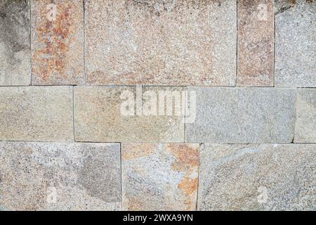 Wall cladding of horizontally arranged stones. Selective focus with shallow depth of field. Stock Photo