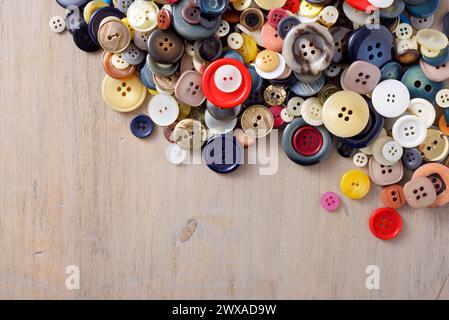Close up of a large group of colorful buttons on a wood table Stock Photo