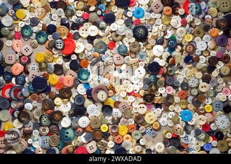 Close up of a large group of colorful buttons on a wood table Stock Photo