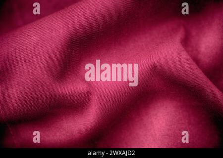 A crumpled magenta fabric texture background. Close up. Stock Photo
