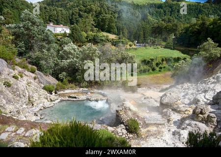 The Caldeiras do Vulcão das Furnas are in different states of activity, some dry and others with a large flow of hot water. Fumaroles, boiling mud and Stock Photo