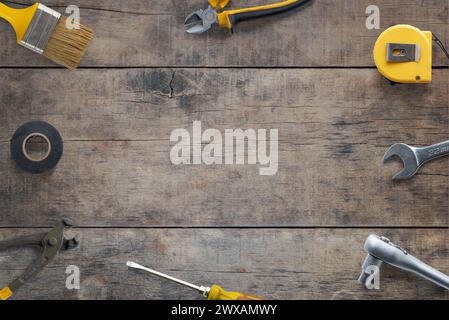 Top view flat lay of tools composition on a wooden table. Copy space in the middle. Ideal for DIY concept promotion Stock Photo