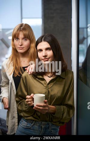 Two confident women clothing designers having break posing Stock Photo