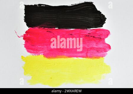 Black, red and yellow lines painted with watercolors similar to the flag of Germany. Stock Photo