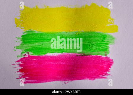 Yellow, green and red lines painted with watercolors on a white background similar to the flag of Lithuania. Stock Photo