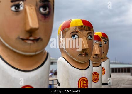 Geelong, Australia - 1 February 2023: The Geelong baths swimming club bollards. These decorated wooden statues are brightly painted and there are many Stock Photo