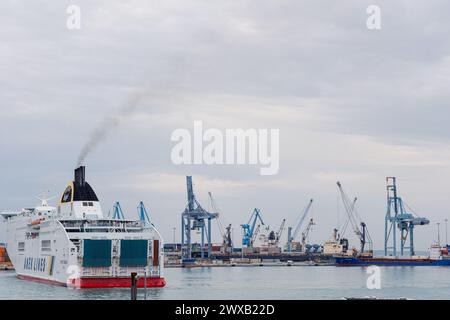 Ancona Italy - 20 Sep 2023: View of the port with many port cranes and a huge liner entering the port. Stock Photo