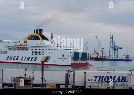 Ancona Italy - 20 Sep 2023: View of the port with many port cranes and a huge liner entering the port. Stock Photo