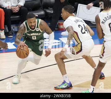 New Orleans, USA. 28th Mar, 2024. Milwaukee Bucks guard Damian Lillard (0) tries to drive past New Orleans Pelicans guard Jordan Hawkins (24) during a National Basketball Association game at the Smoothie King Center in New Orleans, Louisiana on Thursday, March 28, 2024. (Photo by Peter G. Forest/SipaUSA) Credit: Sipa USA/Alamy Live News Stock Photo