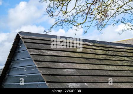 Leatherhead Surrey, UK, March 29 2024, Black Painted Wooden Outdoor Garden Shed With No People Stock Photo