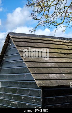 Leatherhead Surrey, UK, March 29 2024, Black Painted Wooden Outdoor Garden Shed With No People Stock Photo