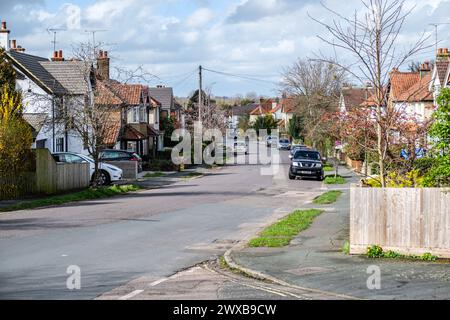 Leatherhead Surrey, UK, March 29 2024, Typical Suburban Residential Housing Street With Parked Cars And No people Stock Photo