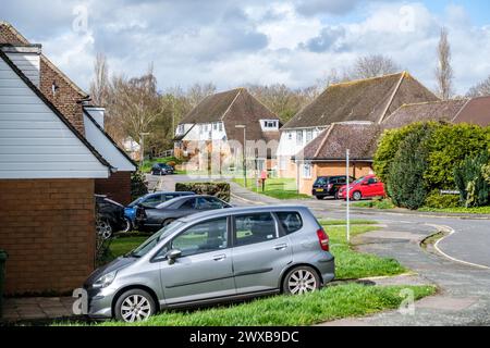 Leatherhead Surrey, UK, March 29 2024, Typical Suburban Residential Housing Street With Parked Cars And No people Stock Photo