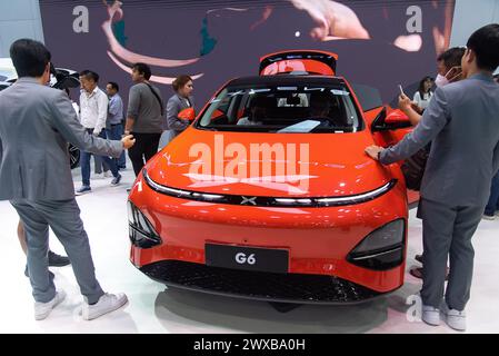 Bangkok, Thailand. 29th Mar, 2024. Visitors inspect a Xpeng G6 car during the 45th Bangkok International Motor Show at IMPACT Muang Thong in Bangkok. The 45th Bangkok International Motor Show 2024 was held at IMPACT Muang Thong in Bangkok where more than 40 leading brands of vehicle manufacturers attended to exhibit their automotive products and technology including the new electric vehicles in the annual automobile showcase. Credit: SOPA Images Limited/Alamy Live News Stock Photo