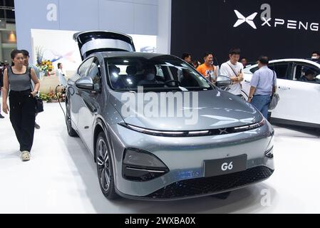 Bangkok, Thailand. 29th Mar, 2024. Visitors inspect a Xpeng G6 car during the 45th Bangkok International Motor Show at IMPACT Muang Thong in Bangkok. The 45th Bangkok International Motor Show 2024 was held at IMPACT Muang Thong in Bangkok where more than 40 leading brands of vehicle manufacturers attended to exhibit their automotive products and technology including the new electric vehicles in the annual automobile showcase. Credit: SOPA Images Limited/Alamy Live News Stock Photo