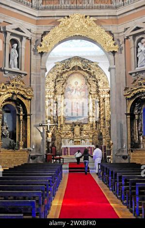 The church Igreja de Santo Ildefonso, Parca da Batalha, Porto, UNESCO World Heritage Site, Sublime church altar with golden decorations and a central Stock Photo