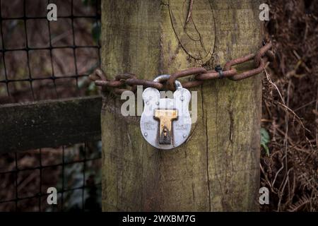 Padlock with rusty chain, outsdoors. Stock Photo