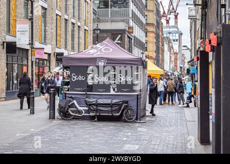 Soho Dairy kiosk at Berwick Street Market, Soho. Established in the 18th century the busy market is still going strong today, Shoppers and tourists. Stock Photo