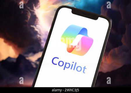 KYIV, UKRAINE - MARCH 17, 2024 Microsoft Copilot logo on iPhone display screen with background of artificial intelligence futuristic ai generated image close up Stock Photo