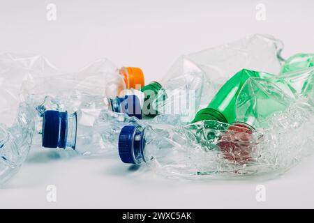 Pile of crushed used plastic bottles on white background. Stock Photo