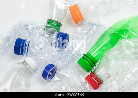 Pile of crushed used plastic bottles on white background. Stock Photo