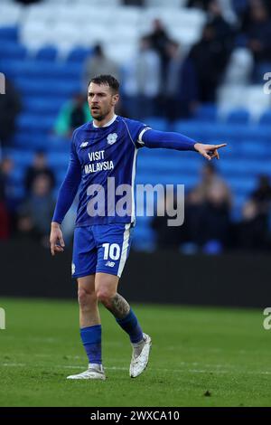 Cardiff, UK. 29th Mar, 2024. Callum O'Dowda of Cardiff City tackles ...